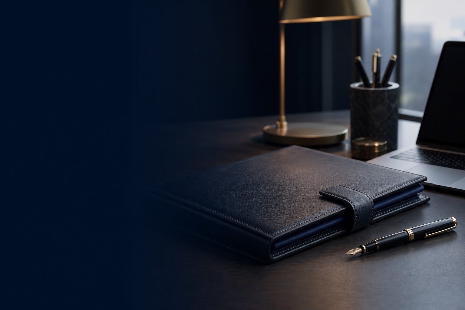 A leather folder and pen ready for signing on a desk